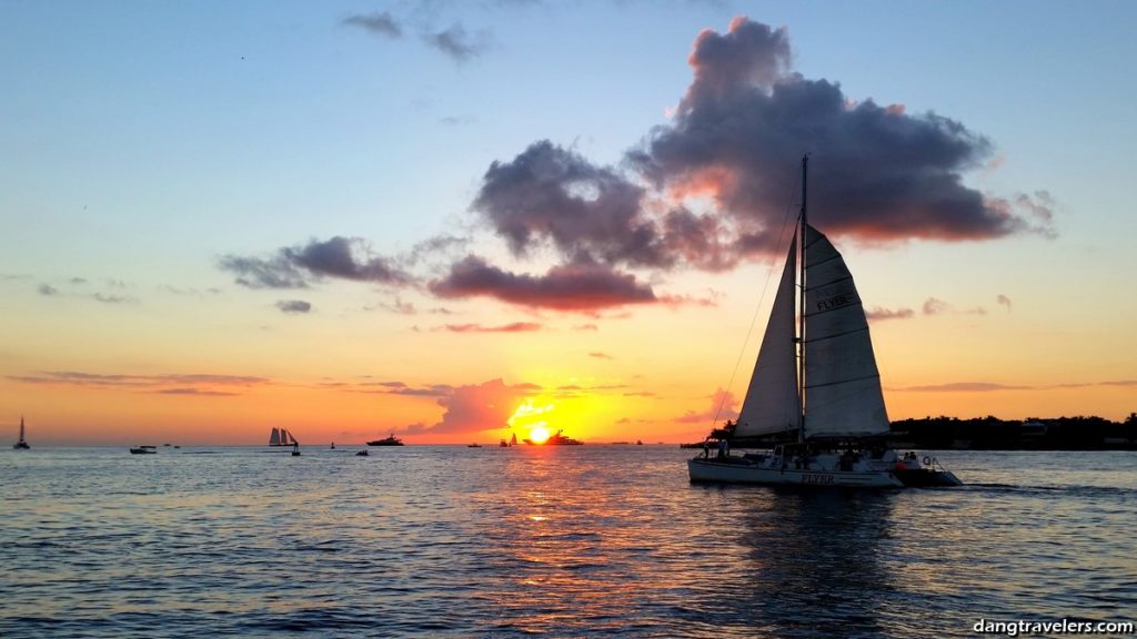 A magical sunset with a sailboat out on the water, one of the romantic things to do in Key West for couples.