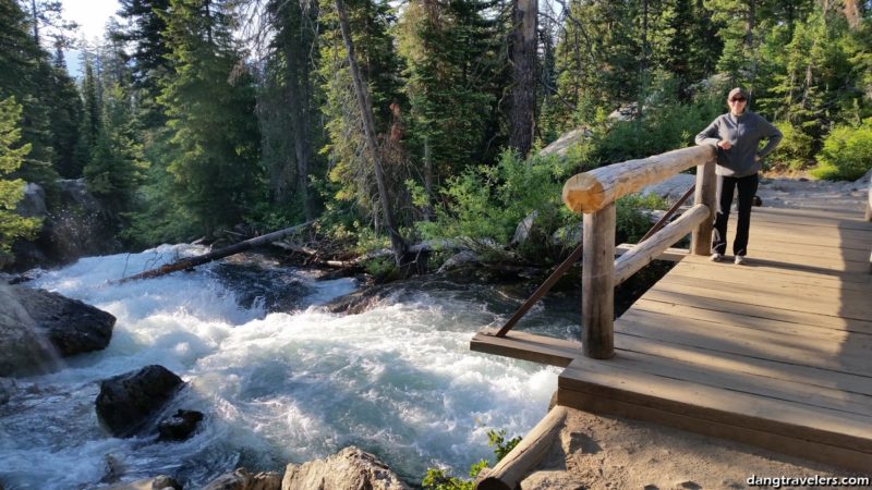 Crossing Cascade Creek bridge on the way to Hidden Falls Grand Teton National Park. 