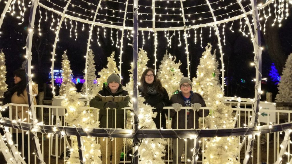 Christmas in Chicago 2022: A lit up bright white globe with Christmas trees at Lincoln Park ZooLights. 