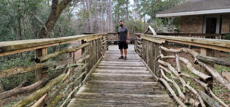 A wooden tree bridge at the Mobile Botanic Garden.