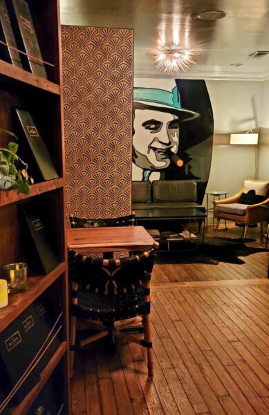 A swinging bookcase opened to a small nook with the back wall painted with Al Capone's face inside the Wilbur Bar in Ocean Springs.