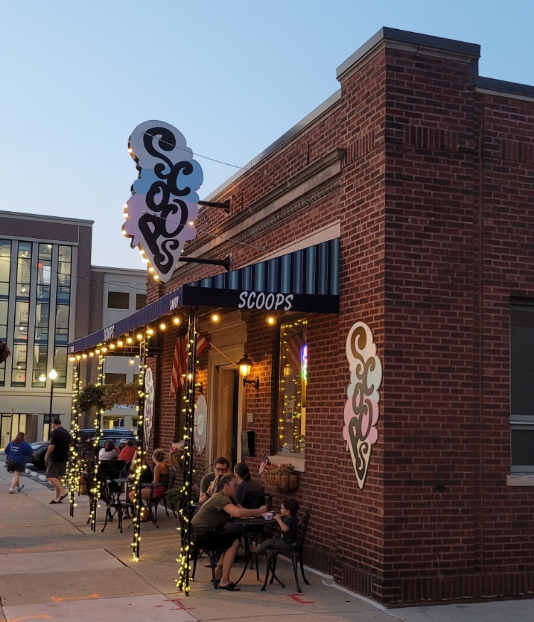 The lit up exterior of Scoops Ice Cream and Candy Shop in Kenosha.