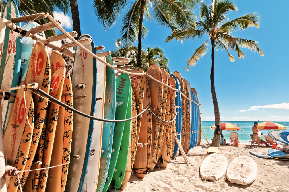 Surfboards lined up in the rack at famous Waikiki Beach in Honolulu, Oahu. Hawaii is one of the warm places to visit in February USA.