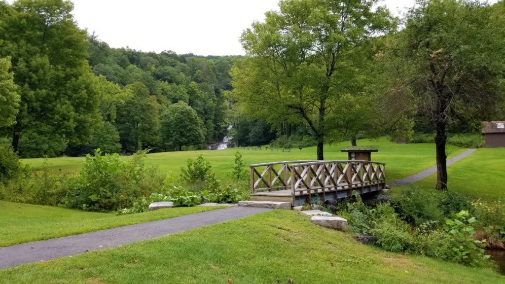 A bridge and waterfalls of Kent Falls State Park