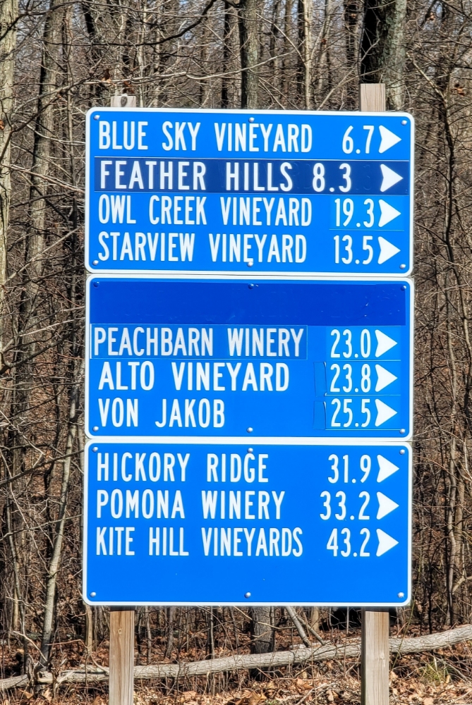 A blue sign designating how far the southern Illinois wineries are.