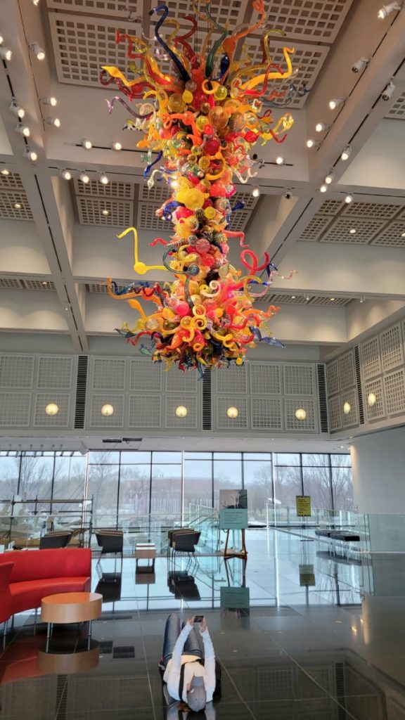 A colorful glass chandelier by Dale Chihuly hanging from the ceiling at the Wichita Art Museum in Kansas.