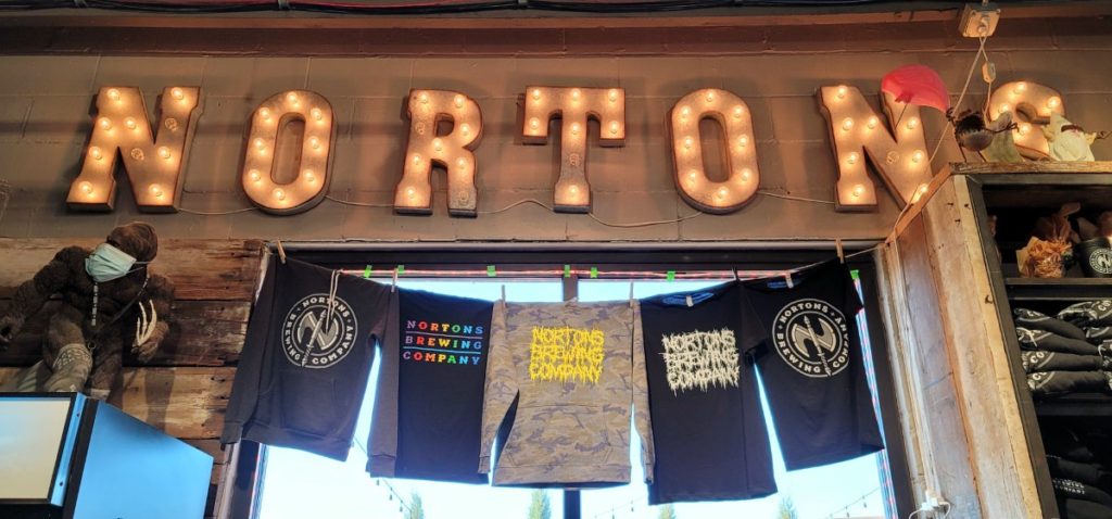 Nortons Brewing Company Tshirts and glowing sign.