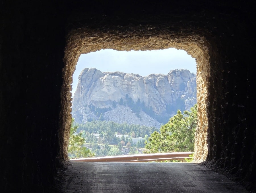 The view of Mount Rushmore through a tunnel on Iron Mountain Road.